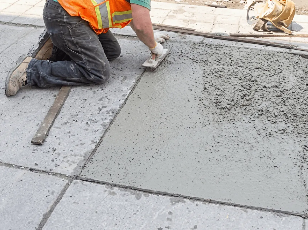 Professional repairing a concrete floor in Dover, DE